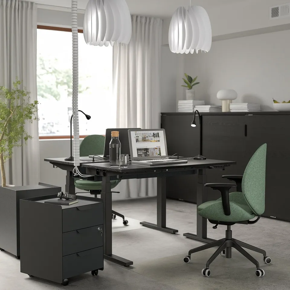 Modern office: MITTZON black sit-stand desk, green chairs, white lamps, black cabinet, dual motors.