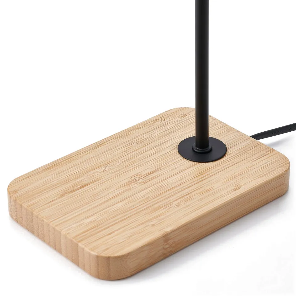 Modern table lamp with sleek metal stem, curved design, and sturdy bamboo base.