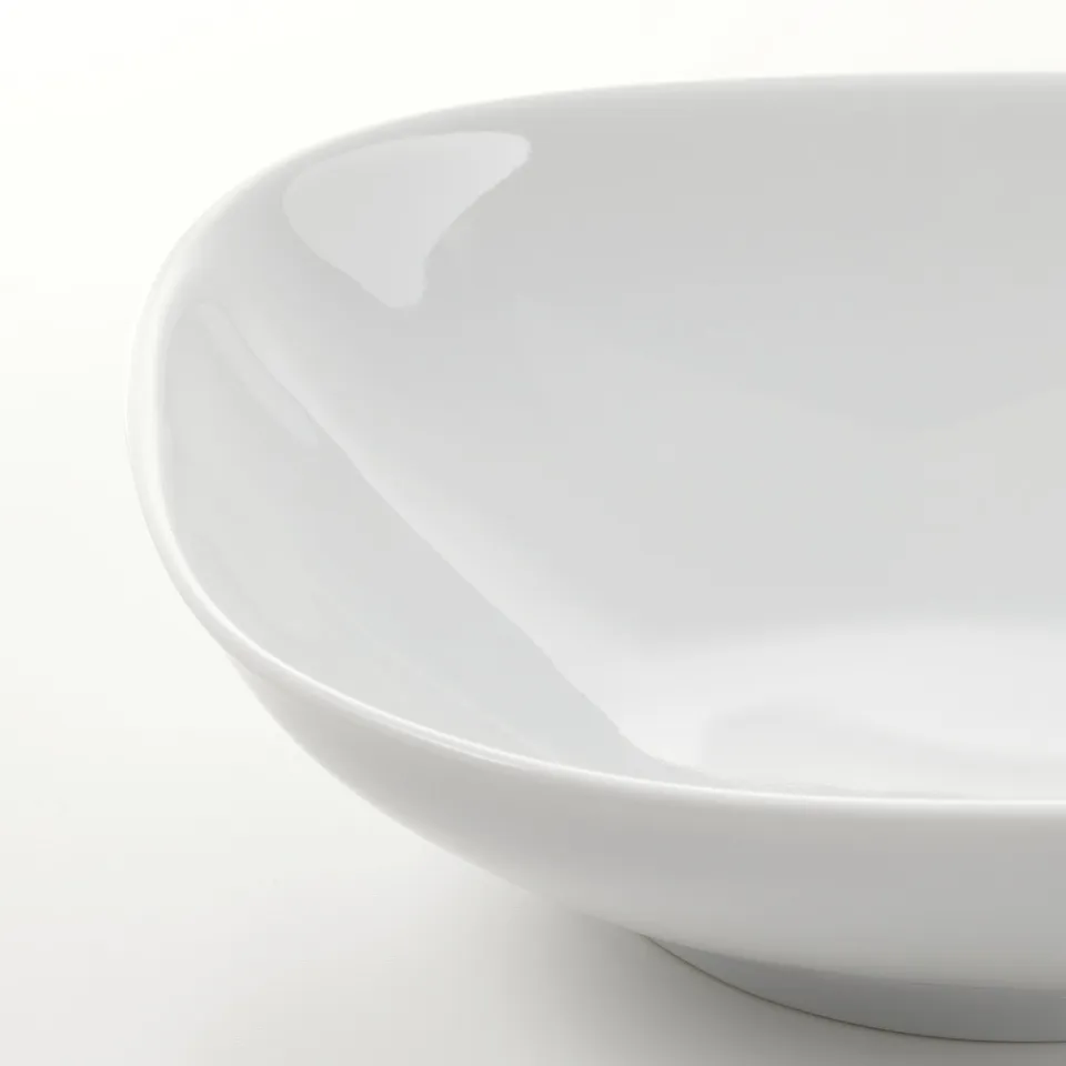 Smooth, pristine white bowl crafted from durable feldspar porcelain, showcasing elegant, rounded design.