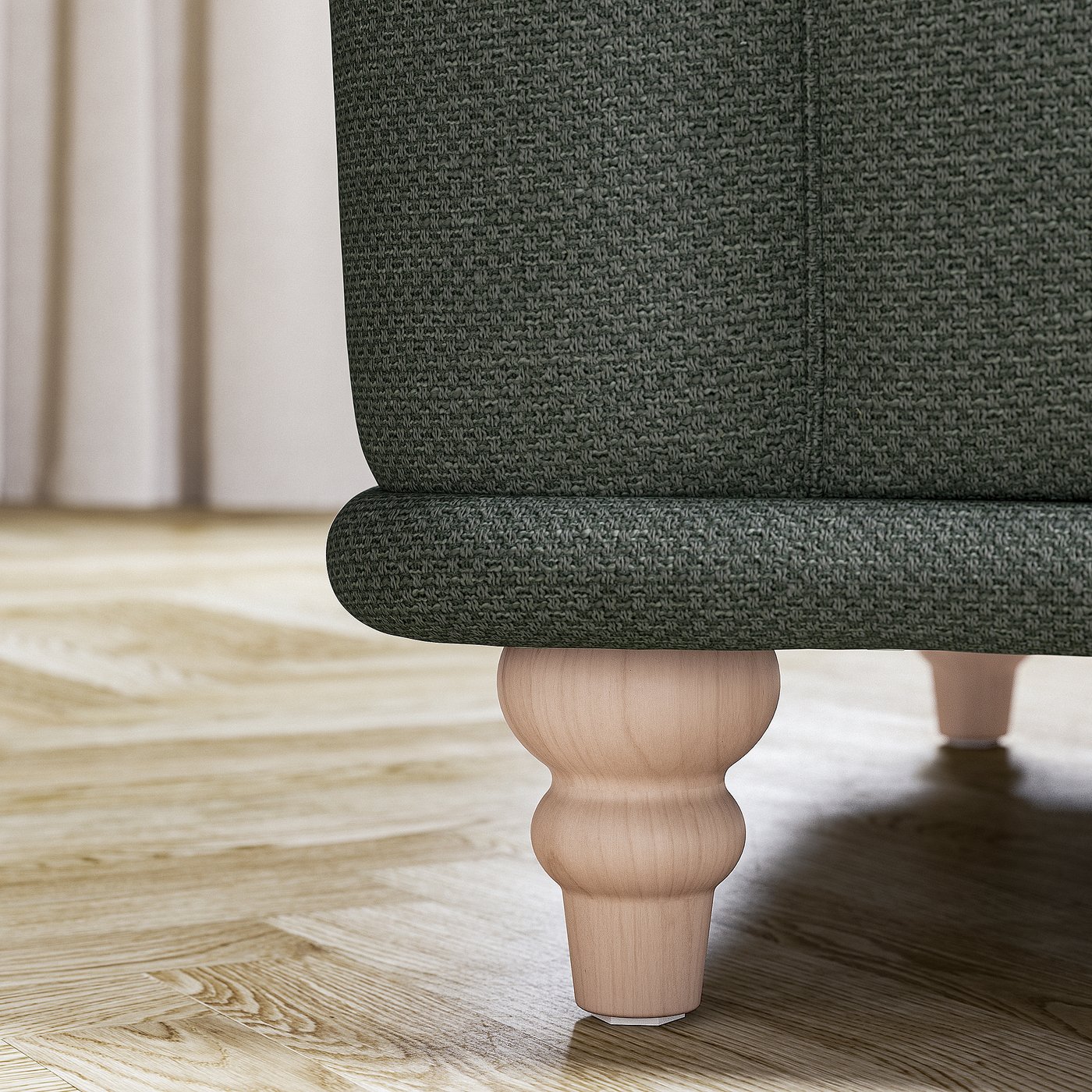 Dark green textured sofa with turned wood legs on wooden floor.