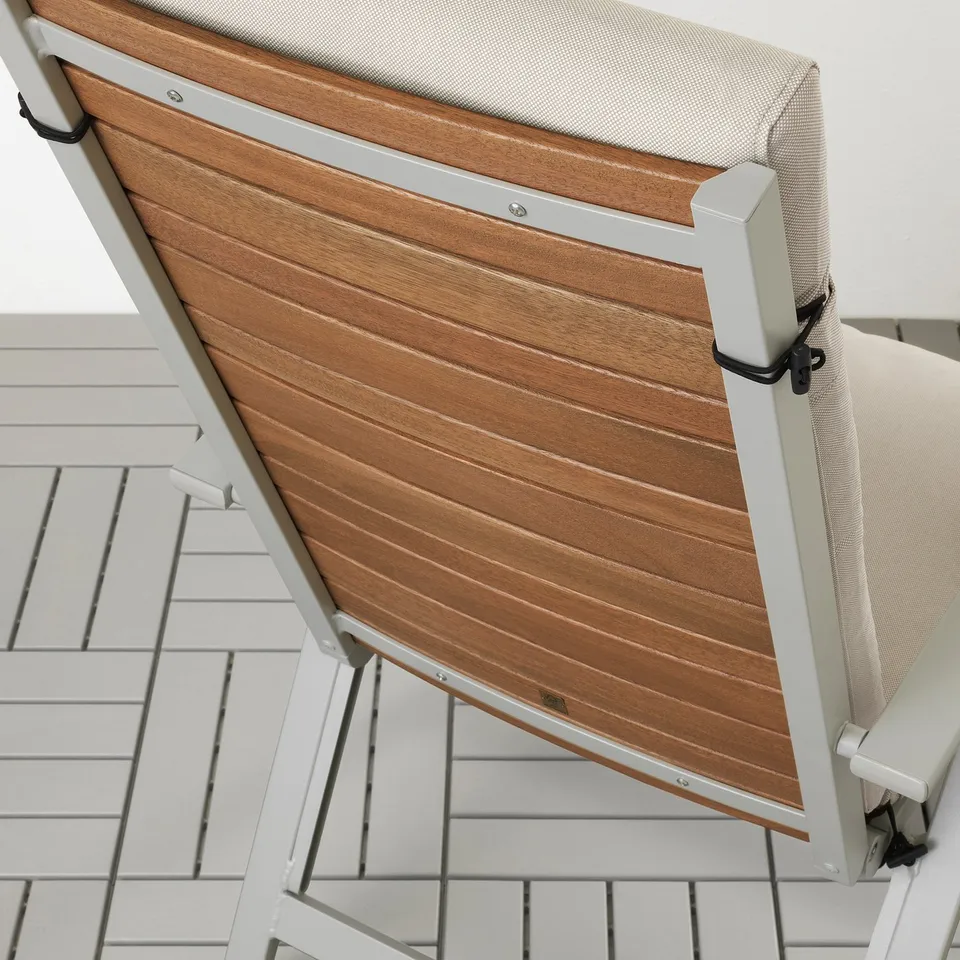 Wooden outdoor chair with beige cushion and adjustable backrest.