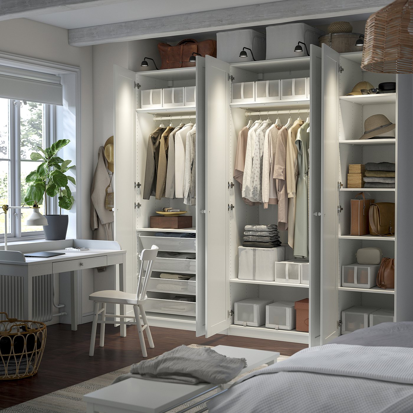 Modern PAX wardrobe with open doors, showing folded clothes and hanging garments.