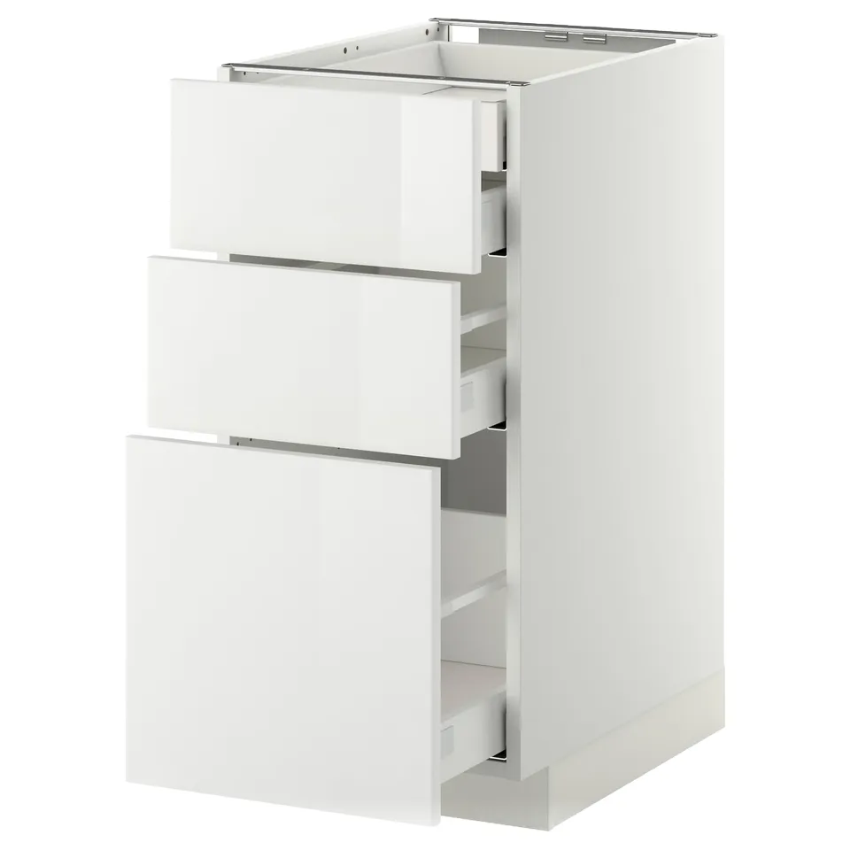 White gloss kitchen cabinet with three open drawers, sleek modern design.