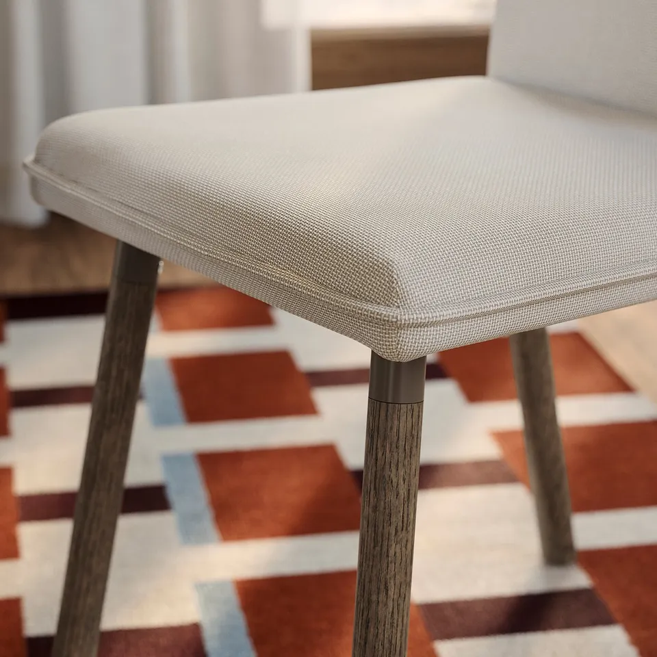 Modern dining chair, beige cushion, sturdy wooden legs. Elegant, high-quality design.
