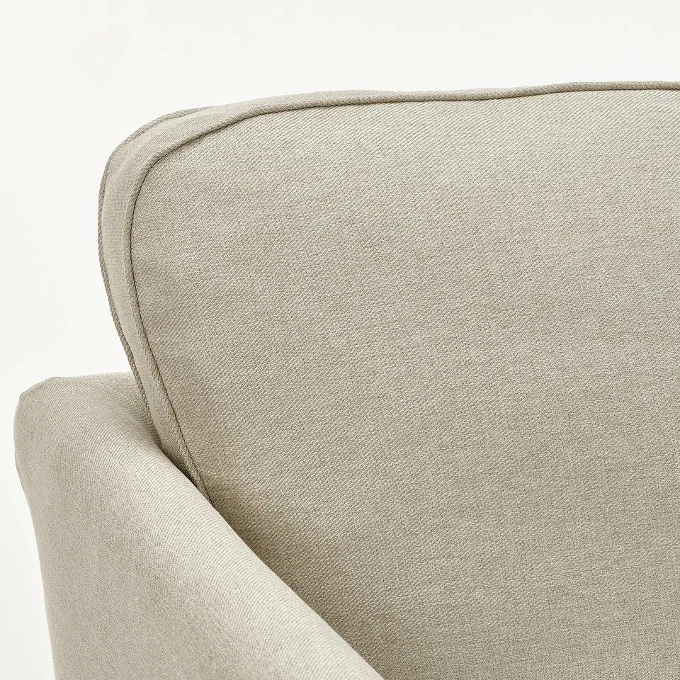 Light-colored sofa with clean lines, fitted cover, and plush interior.