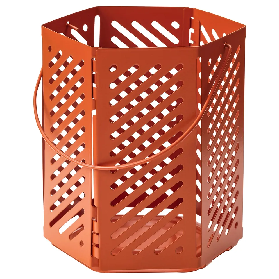 Orange VÅRSYREN lantern with steel, hexagonal cut-outs, casts attractive shadows.
