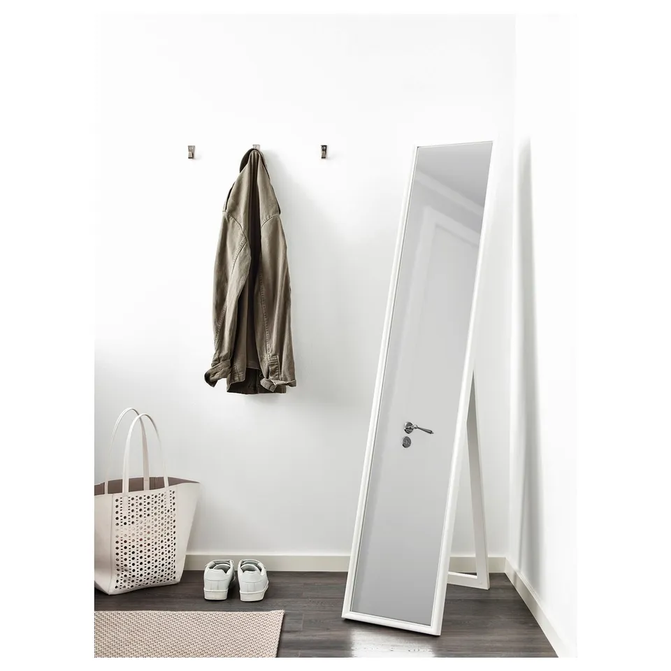 Floor mirror in hallway, leans, safety film, reflects coat.