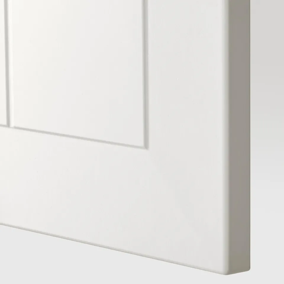 Close-up of sleek, white, high-quality kitchen cabinet door with smooth edges.