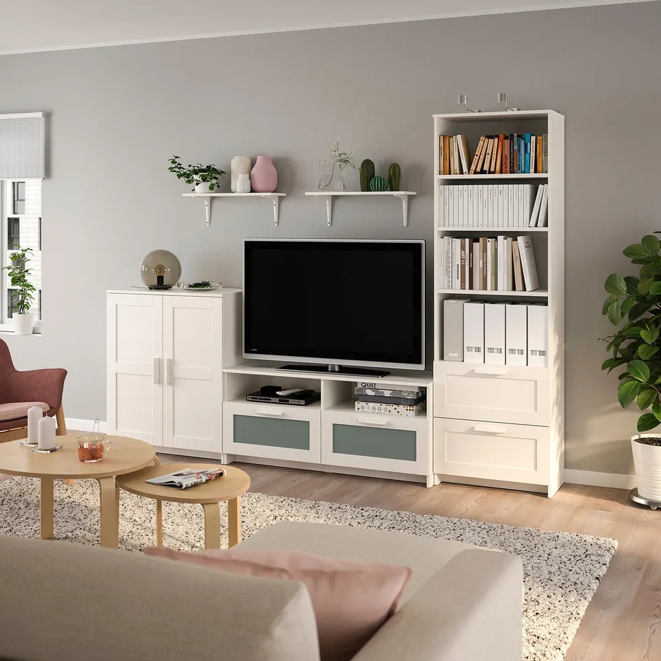Contemporary living room with BRIMNES white furniture, plants, and tv.