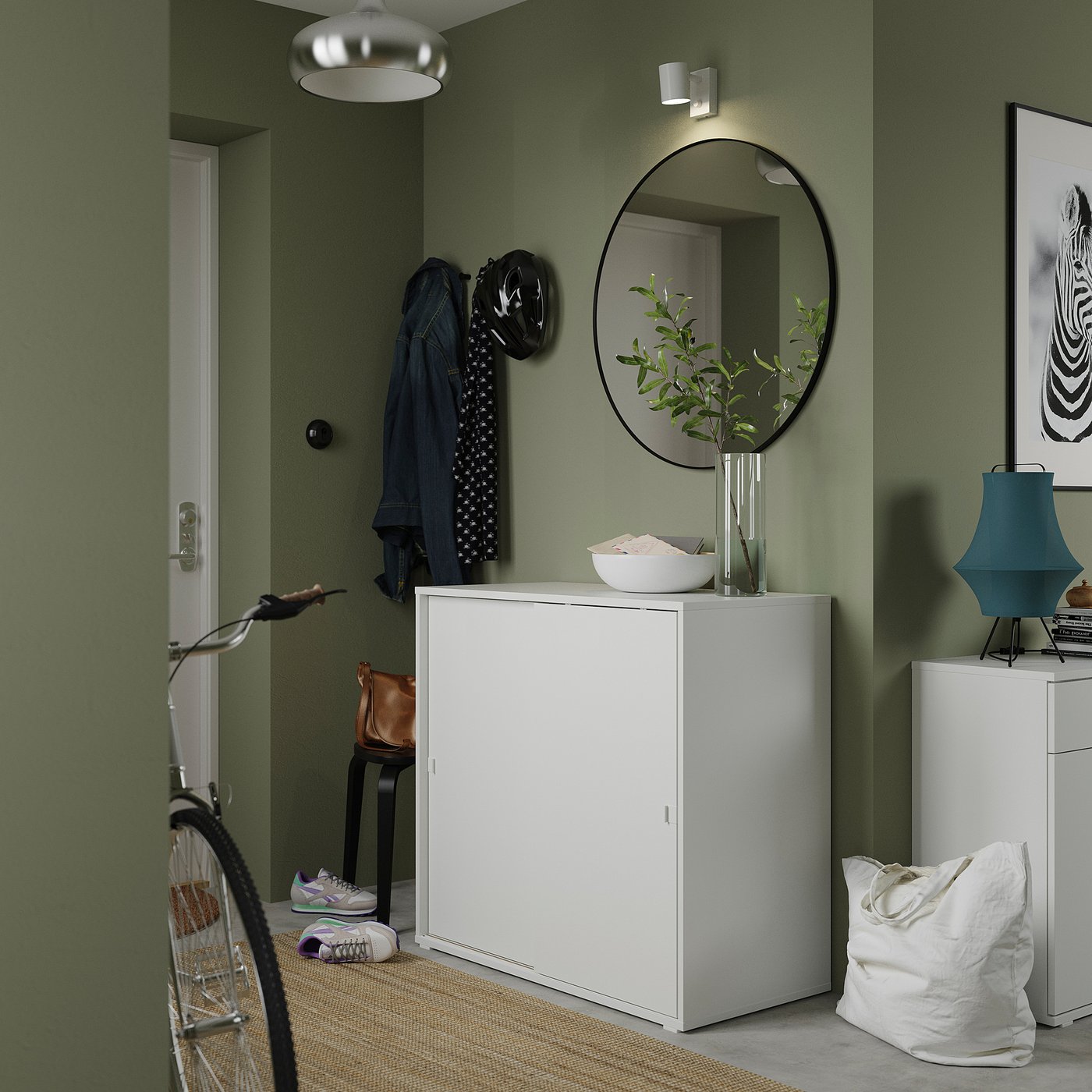 Entryway with green walls, VIHALS cabinet, mirror, light, and bicycle.