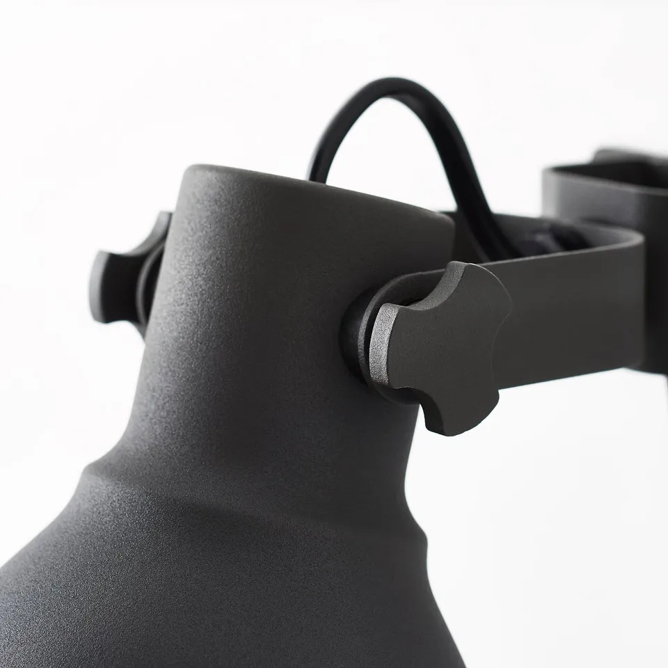 Close-up of robust, adjustable black industrial-style lamp, showcasing sturdy, adjustable metal design.