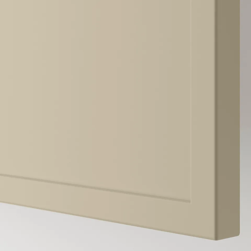 A close-up of a high-quality beige cabinet front with a sleek matte finish and a polished frame.