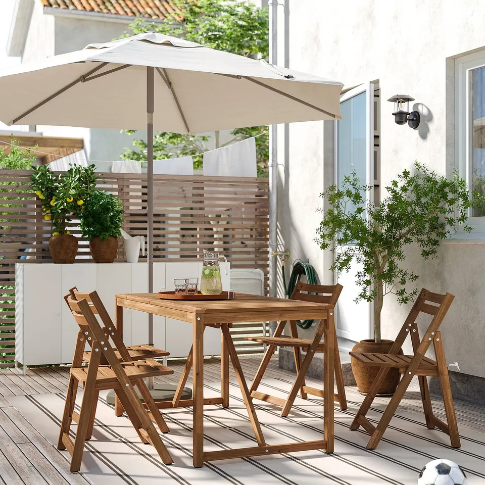 NÄMMARÖ patio set with table, 4 chairs, umbrella, plants, and cabinet.