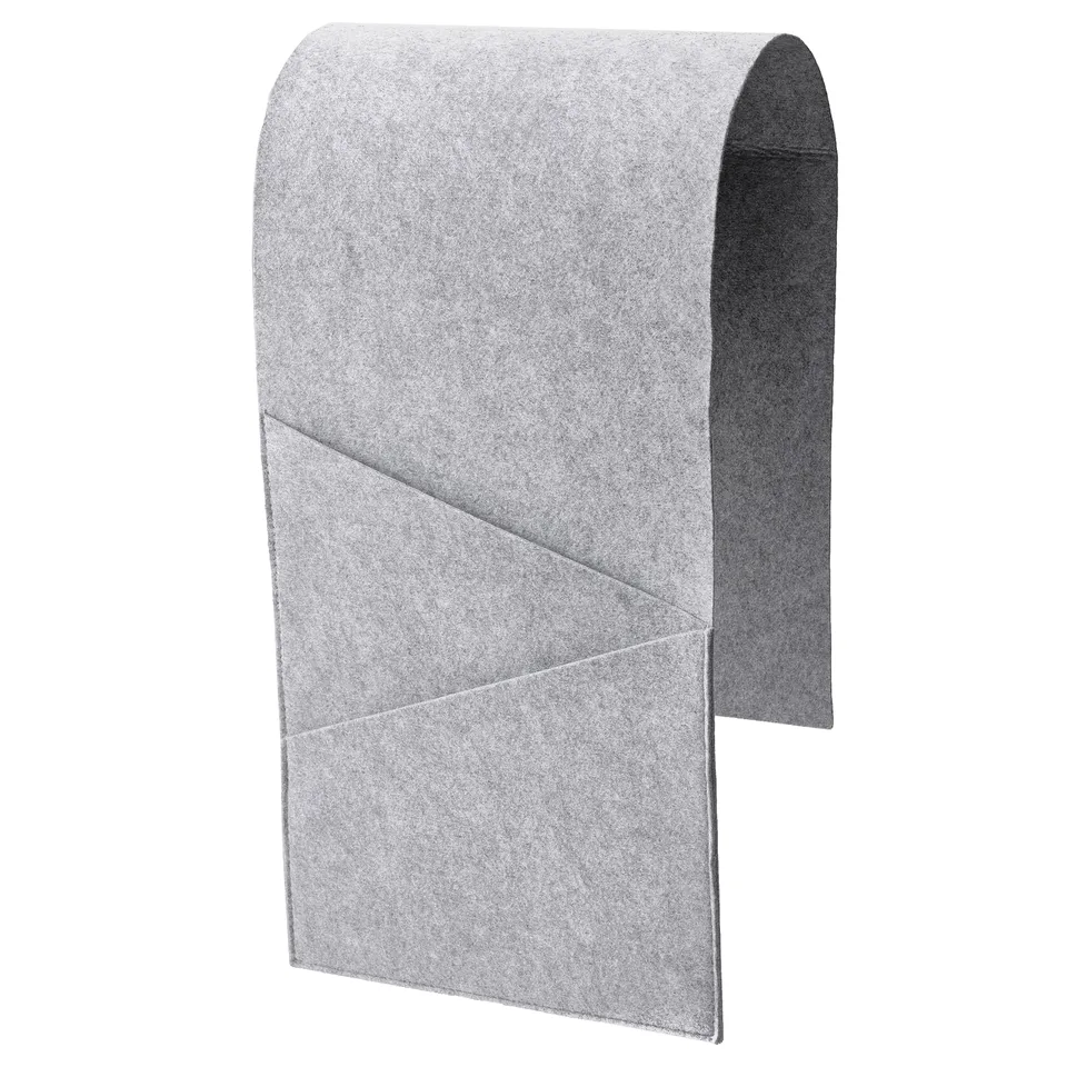 A grey SILÄNG storage pocket with felt material, designed to hang over furniture arms, keeping items organised.