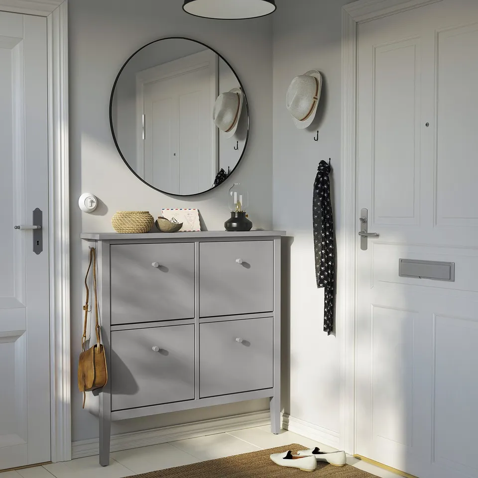 Modern grey shoe cabinet with 4 compartments, round mirror, hooks, and elegant design.