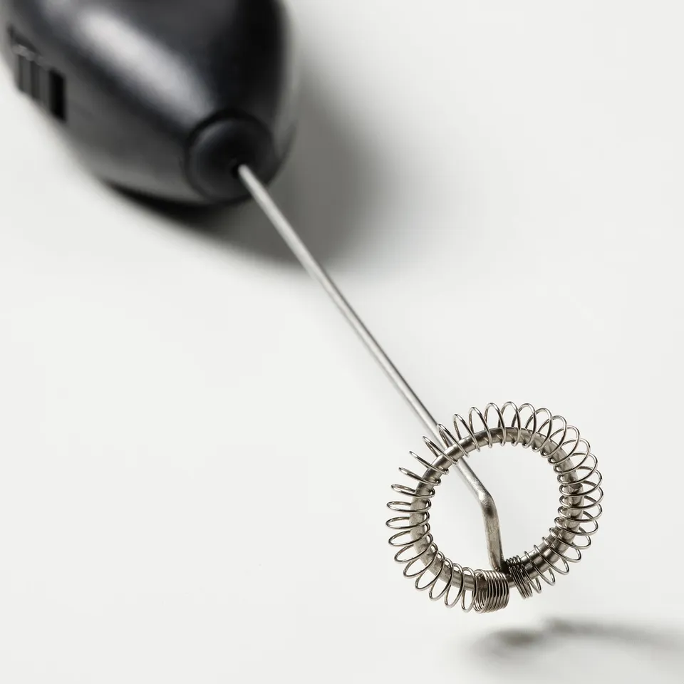 Close-up of electric milkers spiral attachment, highlighting quality stainless steel design.