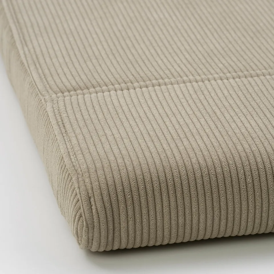 Close-up of plush, textured corduroy footstool cover. Soft, wide-wale, durable.
