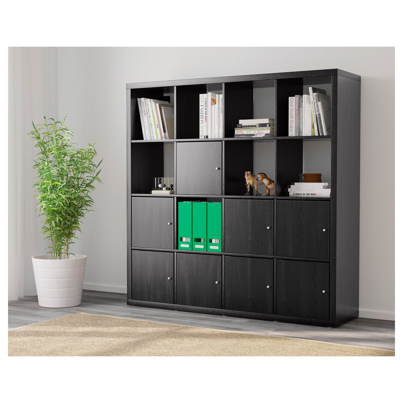 Black KALLAX shelving unit, combining open and closed storage. It divides space while neatly organising books and hiding items.