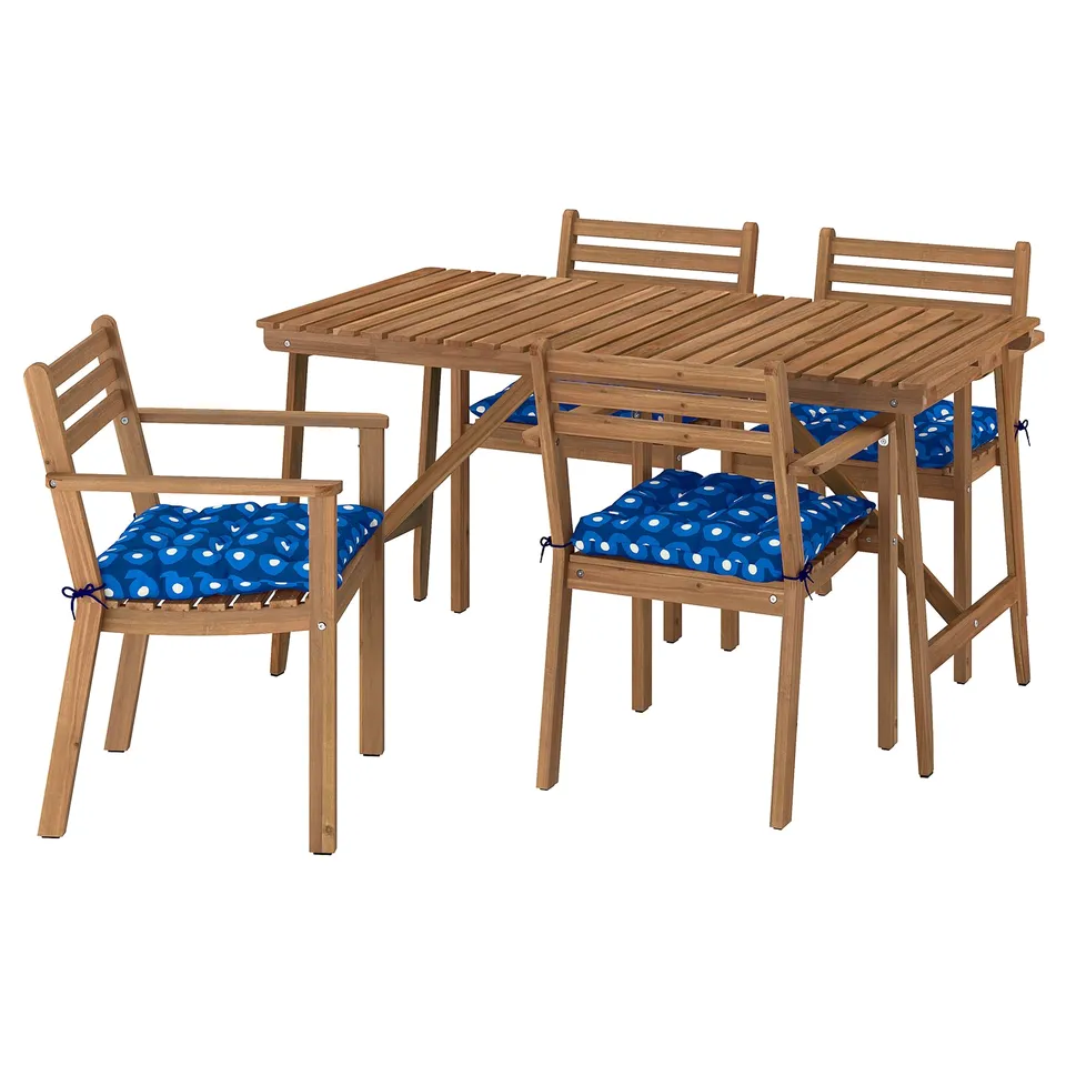 Outdoor patio set: brown acacia table and 4 chairs with blue patterned cushions.