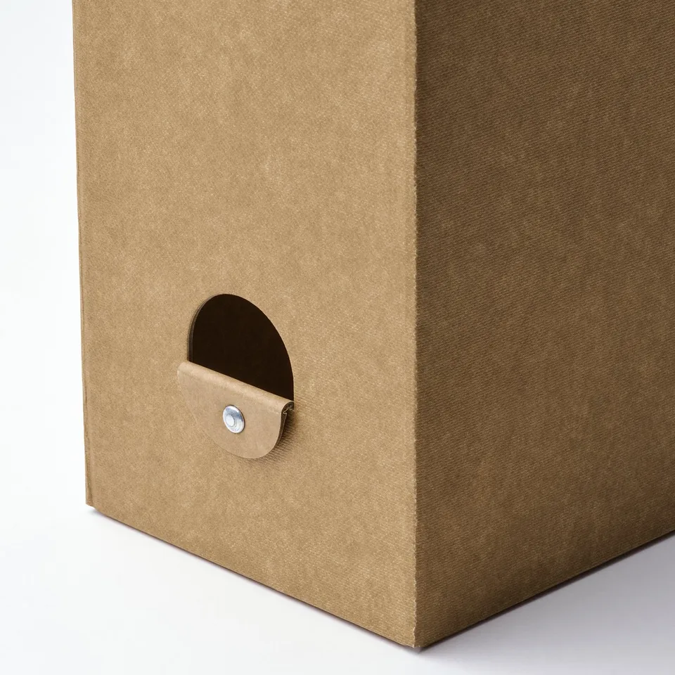 A beige cardboard magazine file with a half-moon cutout and a metal fastener for easy access.
