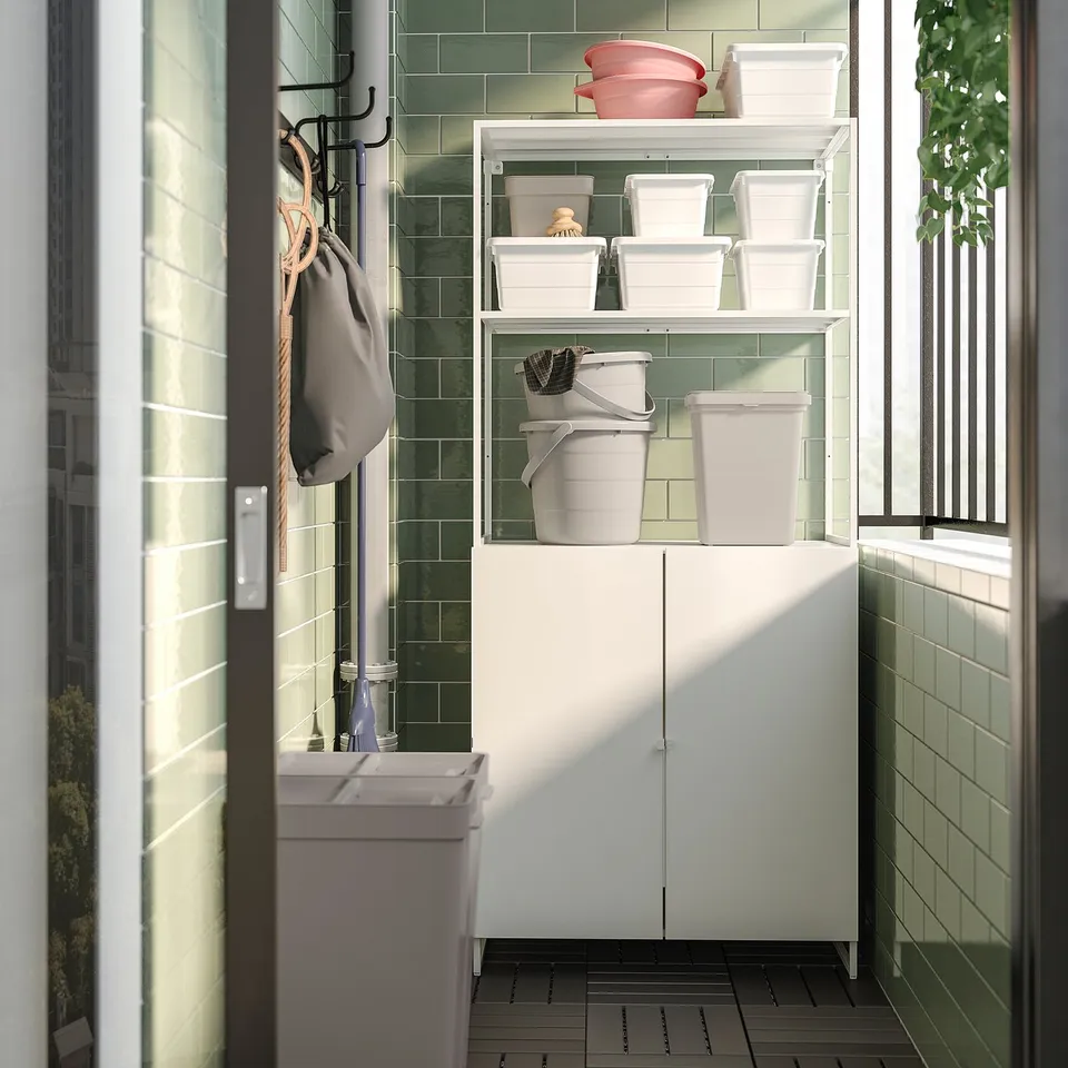 White metal storage unit with shelves and bins, hanging bags, and a tiled wall background.
