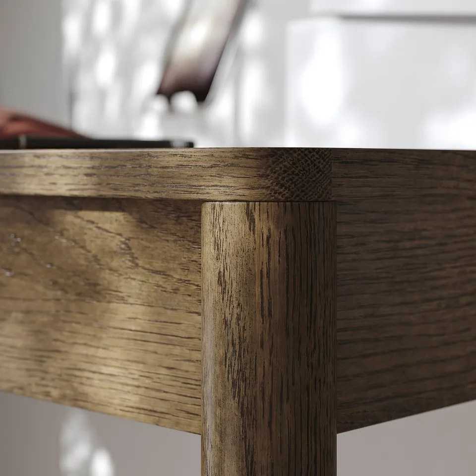 Close-up of a wooden tables corner, showcasing detailed oak veneer texture and precise joinery design.