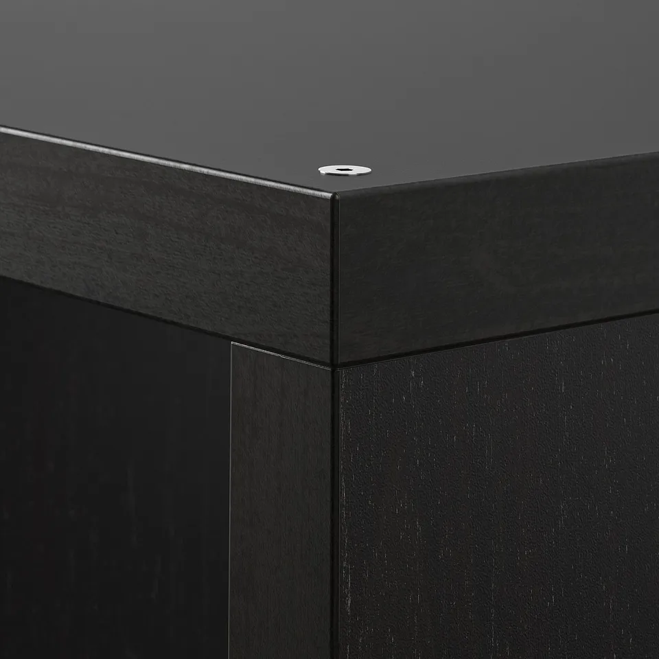 Closeup of KALLAX shelfs sleek, black corner joint; smooth finish, modern design.