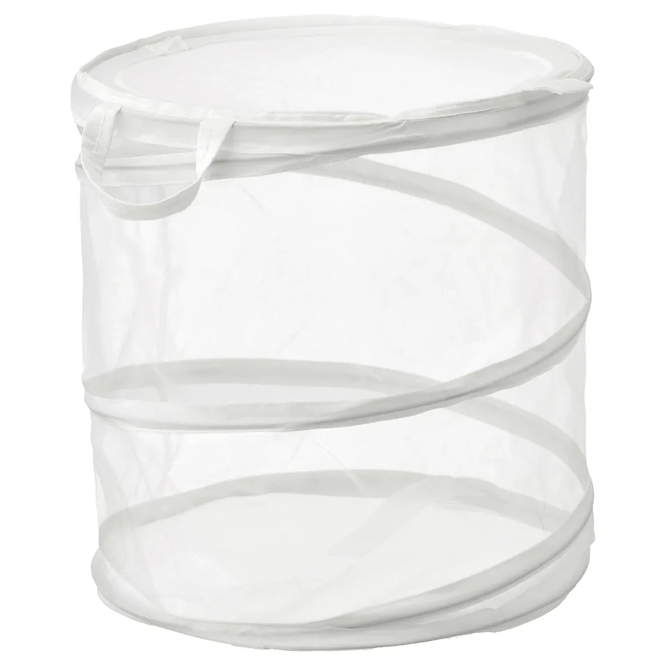 A white FYLLEN laundry basket. It is cylindrical, made from a mesh-like material, and handles for easy transport.