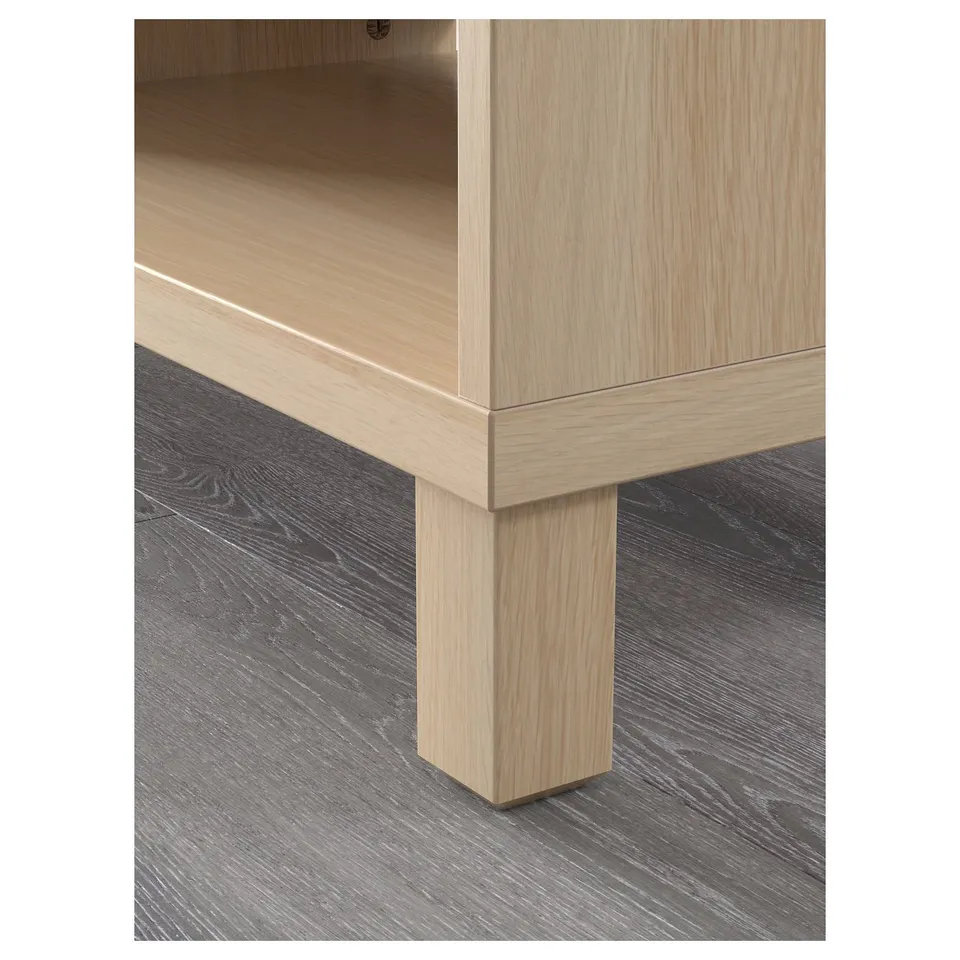 Close-up of a modern light oak tv bench with adjustable shelves and clean, sleek design.