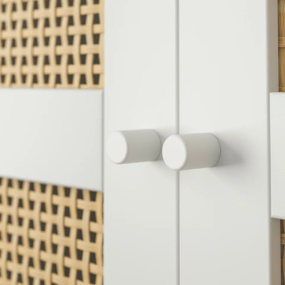 Modern white cylindrical wall hooks on white wall, bamboo wall decor.
