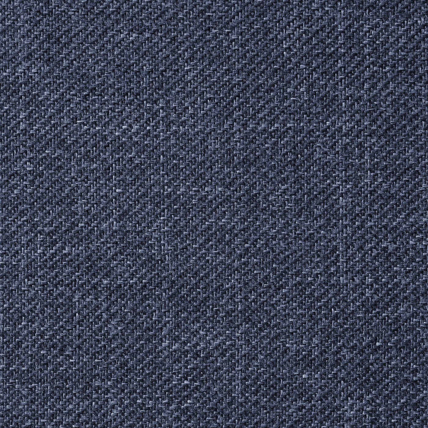 Close-up of high-quality, dark grey upholstered fabric. Soft texture, tight weave, melted appearance.