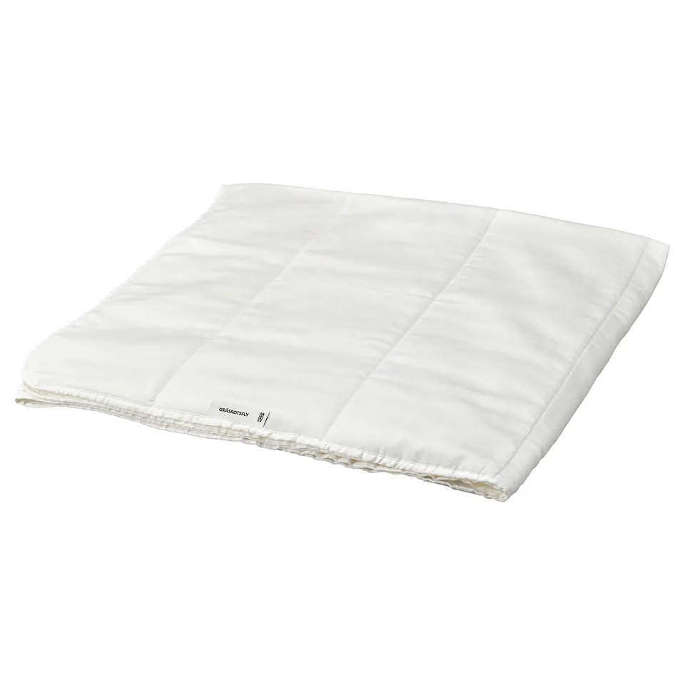 A white GRÄSROTSFLY duvet with silky lyocell fabric and polyester/viscose filling. It has a smooth, rectangular shape with simple stitching details.