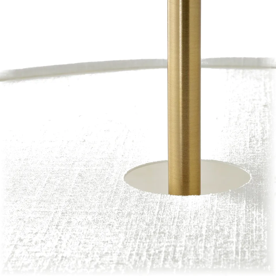 Gold lamp post on white travertine base, elegant and sturdy design.