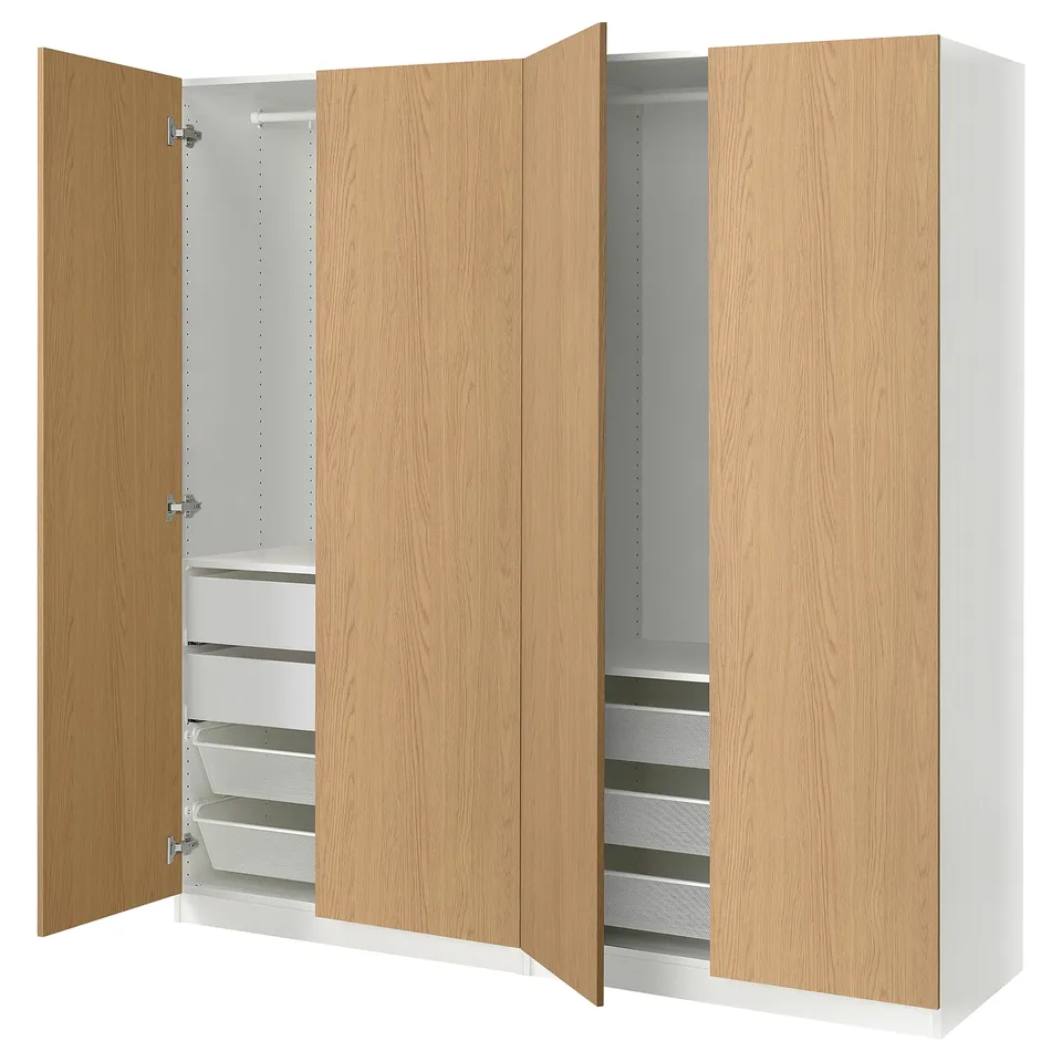 An open ikea PAX wardrobe in oak and white, featuring drawers and shelves.