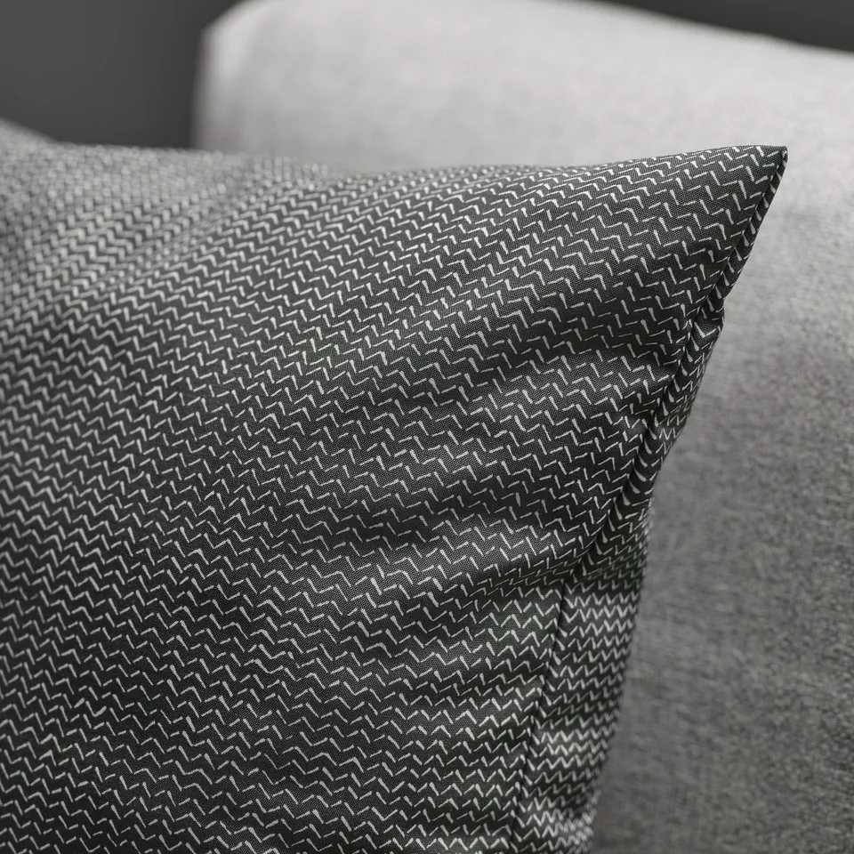 Close-up of textured, patterned cushion with subtle sheen.