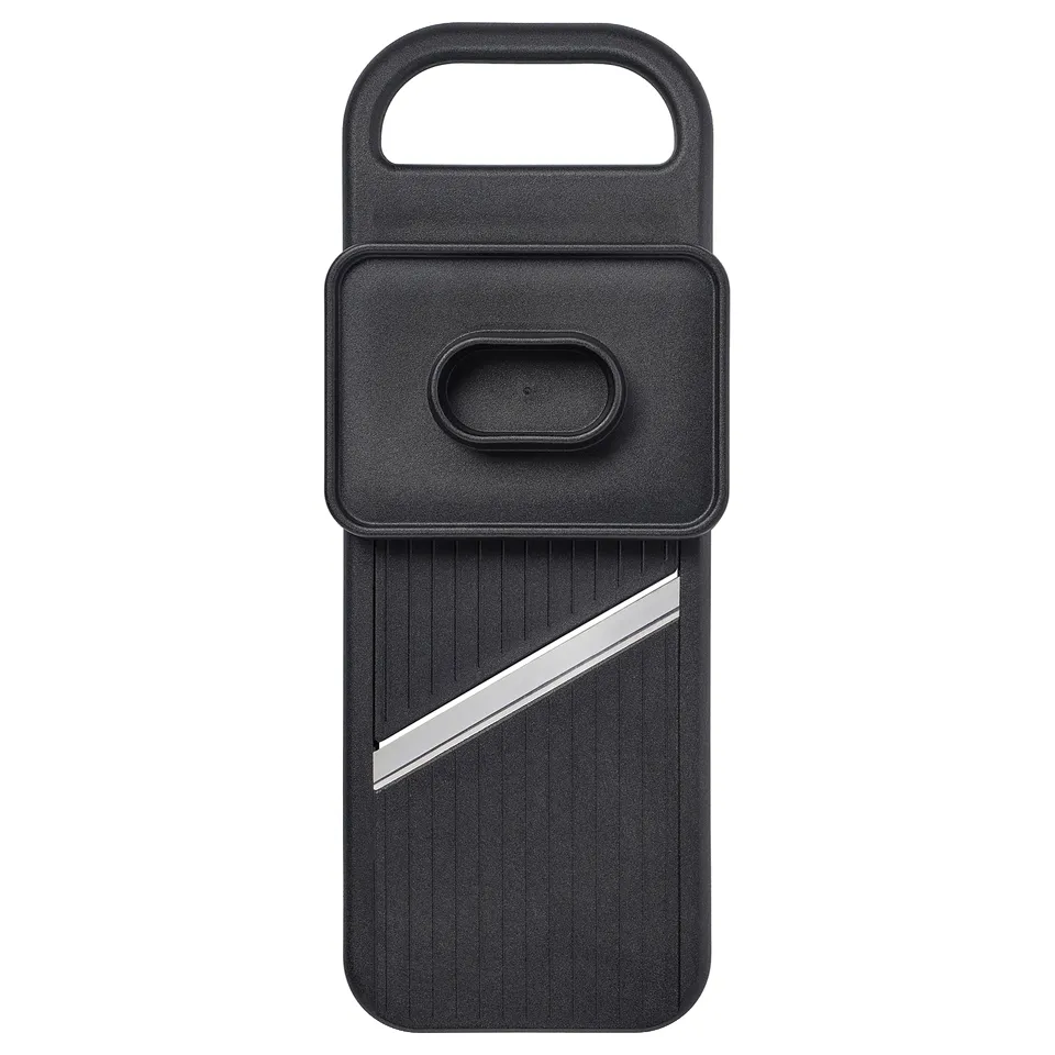 Black IKEA 365+ slicer with stainless blade, textured grip, handle, resting stand, and thickness adjuster on back.