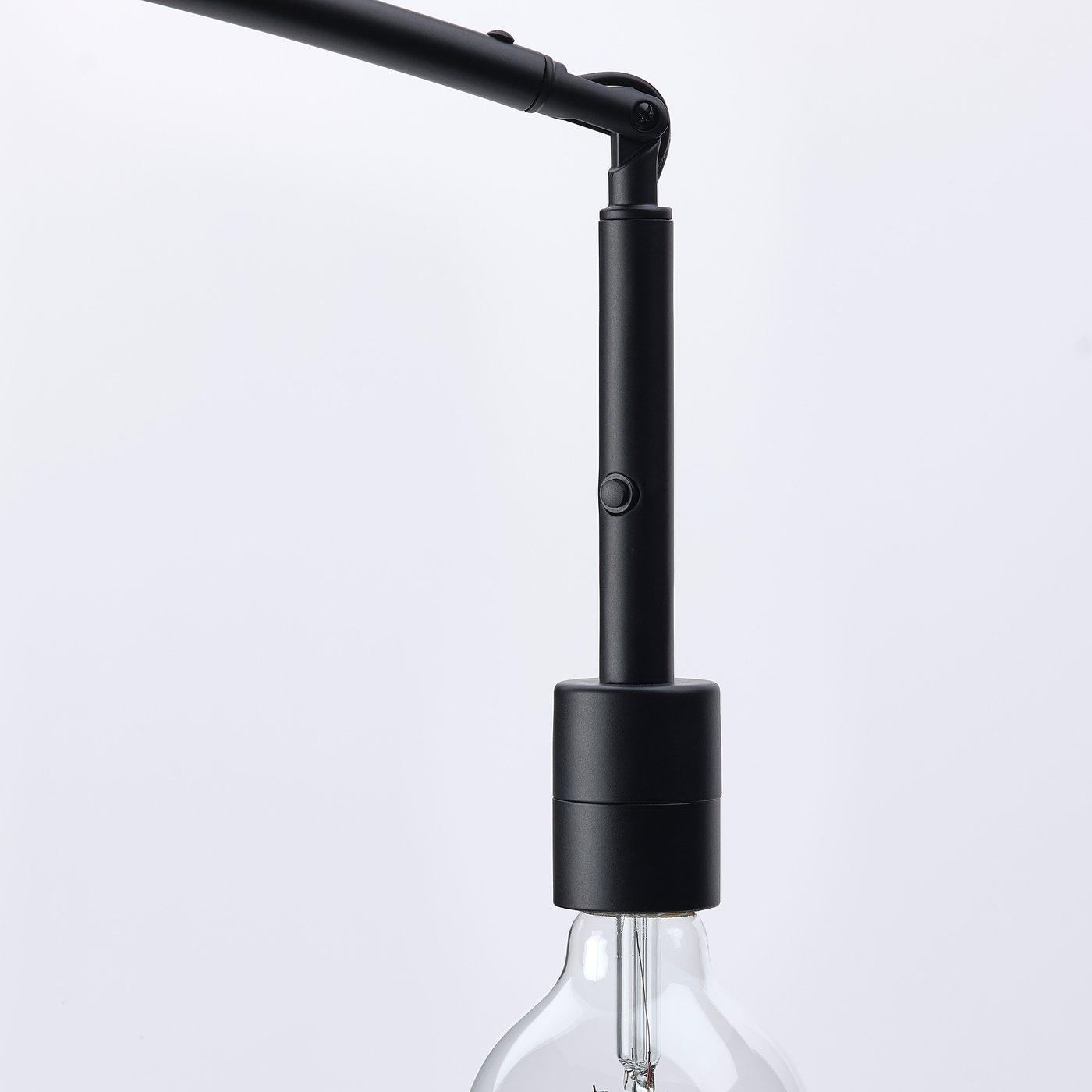 Black modern floor lamp with adjustable arm and exposed light bulb.