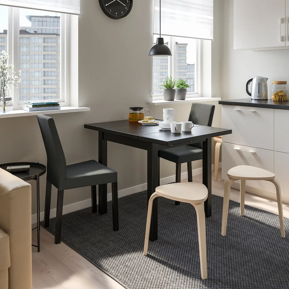 Modern dining setup with foldable NORDVIKEN table for small spaces, enhanced by bright window views.