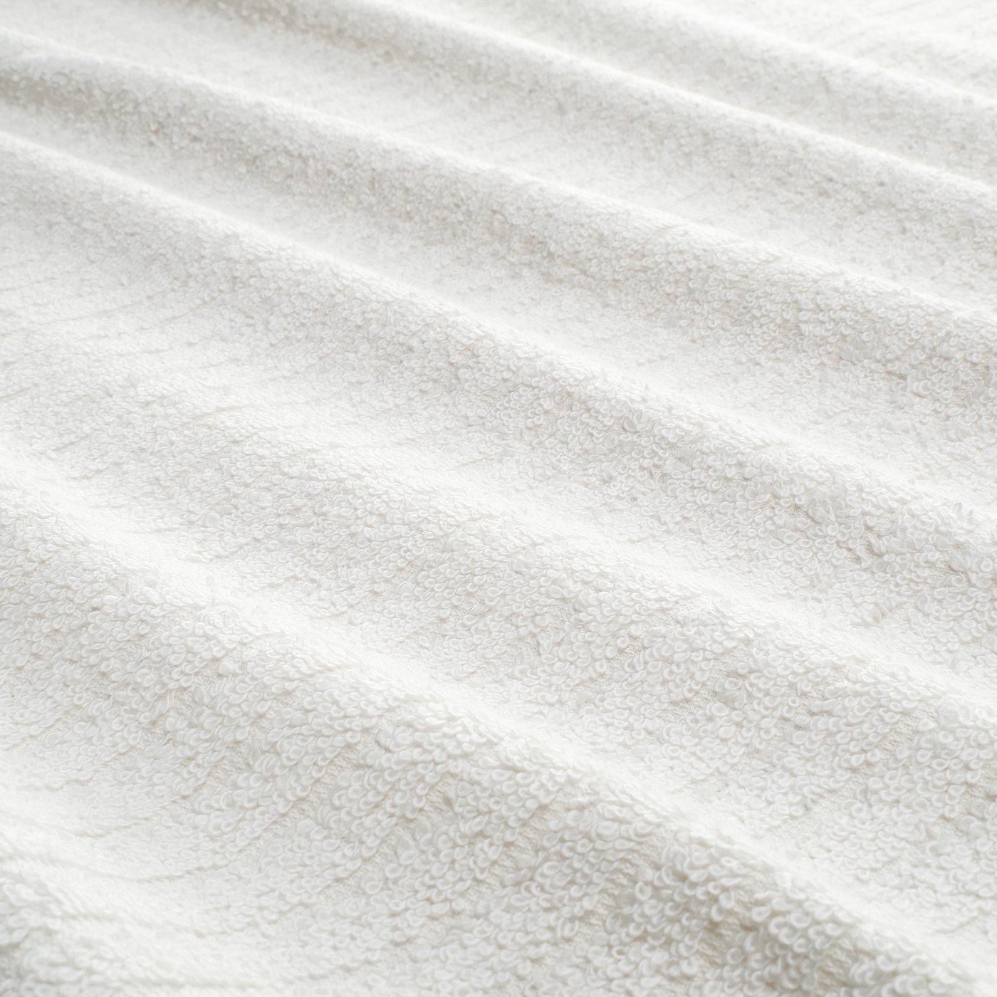 Close-up of a soft, terry cloth towel with distinct stripes, showcasing its textured, absorbent surface.