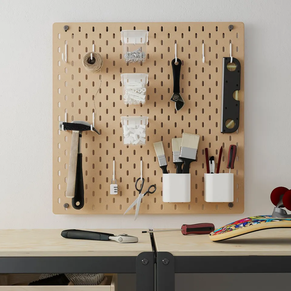 SKÅDIS pegboard organises tools; mounted on wall, larger than desk items.