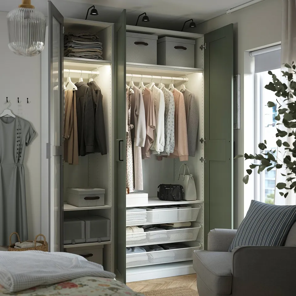 Modern closet with mirror doors, built-in lighting, shelves, drawers, and clothes hangers.