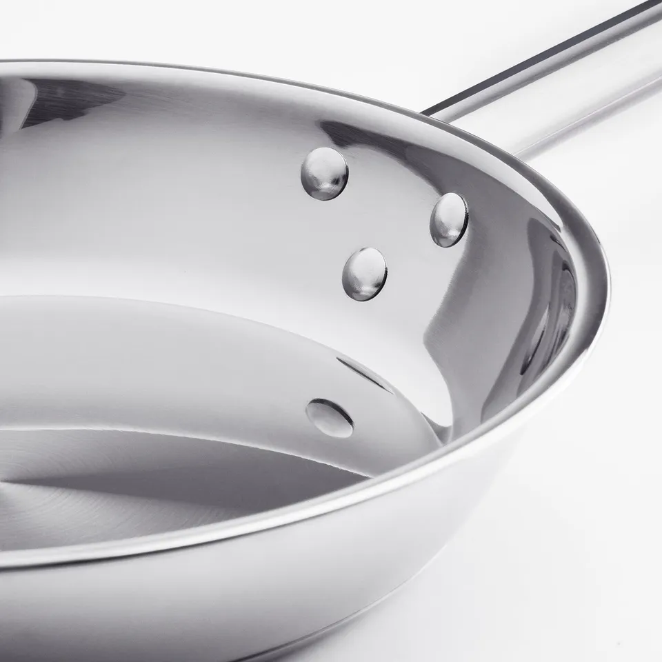 High-quality stainless steel pan with even heat distribution, durable coating, and induction hob compatibility.