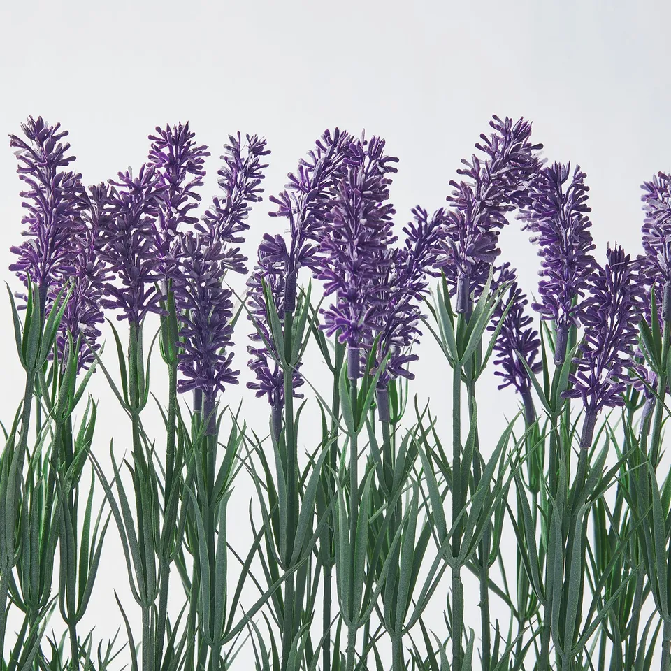 Lifelike artificial lavender, vivid purple flowers, green stems, realistic leaves.