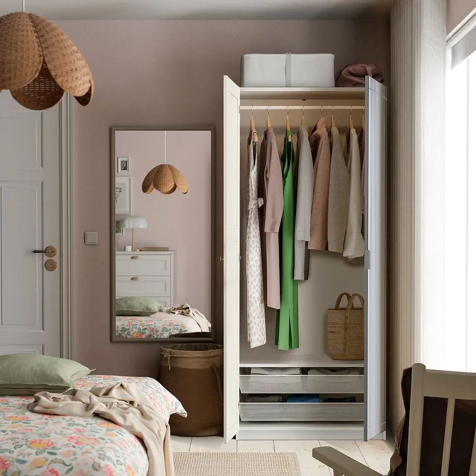Open closet with hanging clothes, top shelf, drawers below.