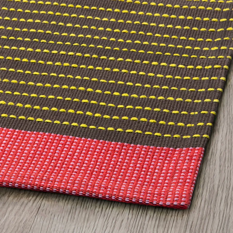 Rug with patterned texture, yellow and red stripes, high-quality cotton material.