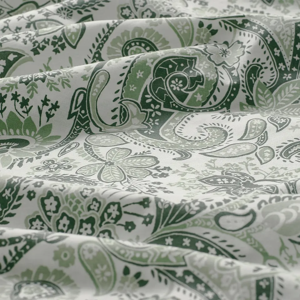 Close-up of green paisley pillowcase, showcasing intricate patterns and high-quality fabric texture.