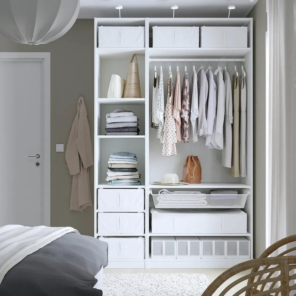 Organised closet with clothes, shelves, and storage boxes.