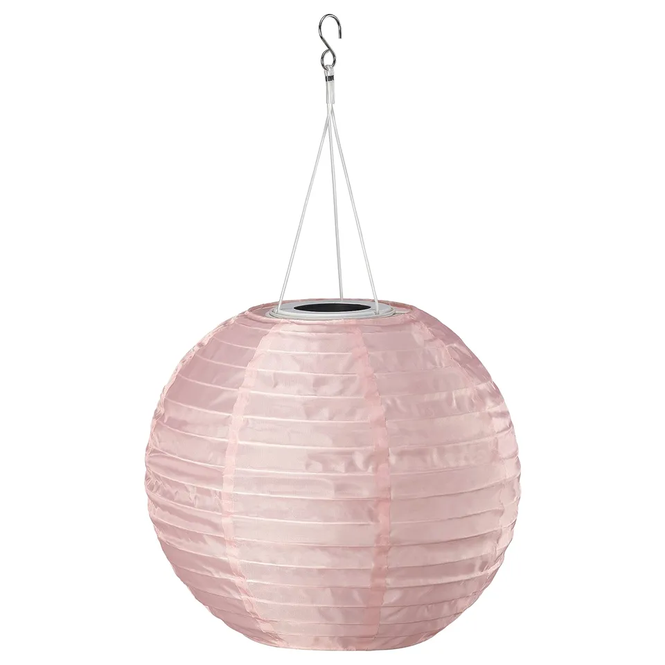 SOLVINDEN outdoor solar light, light pink, round shape, folded design, hangs from a hook.