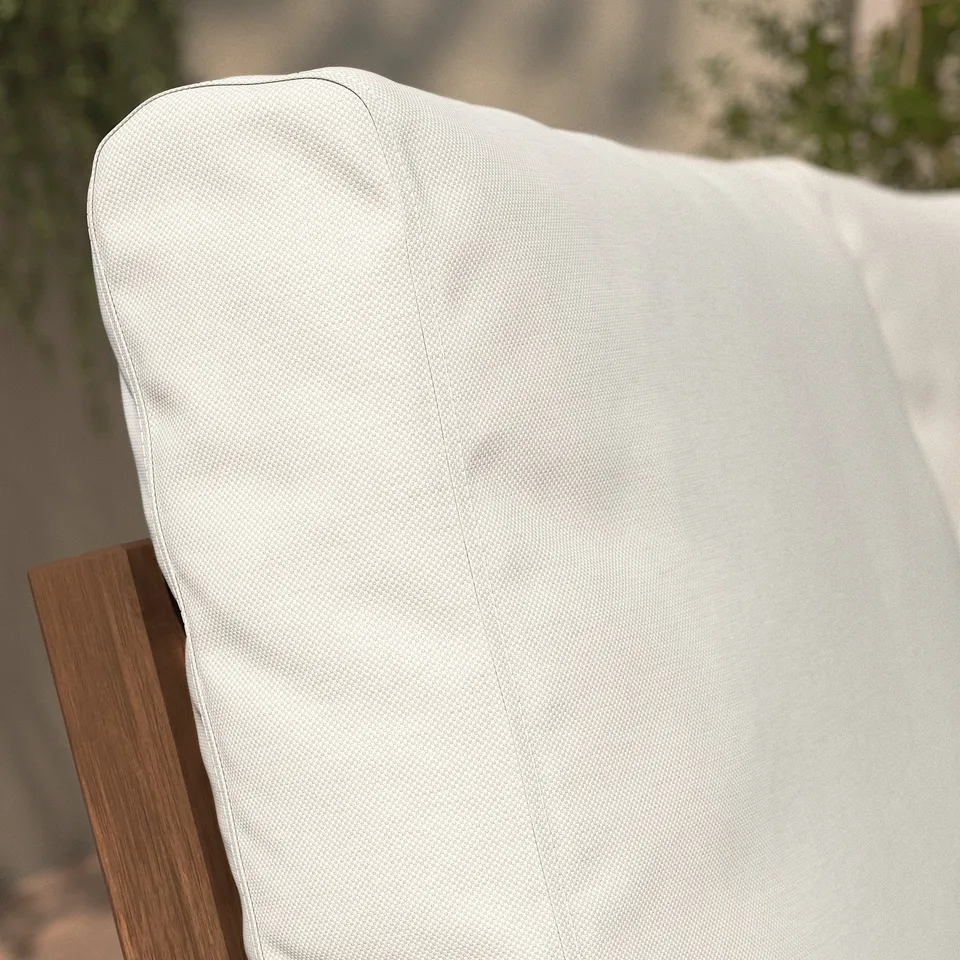 A close-up of a white outdoor sofa cushion, showcasing its plush texture and quality fabric, designed for comfort and durability.