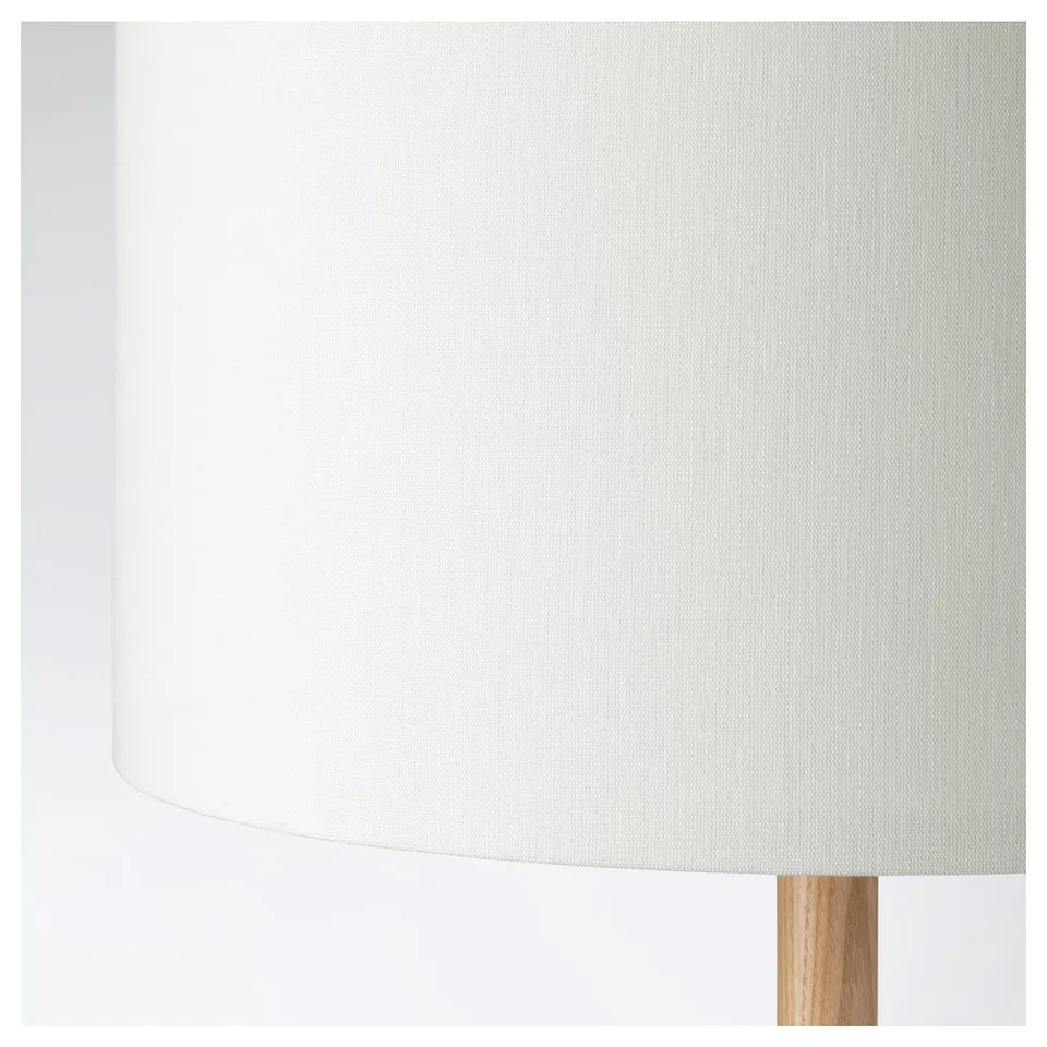 Modern floor lamp with white shade and wooden base. Elegant, adjustable, eco-friendly design.